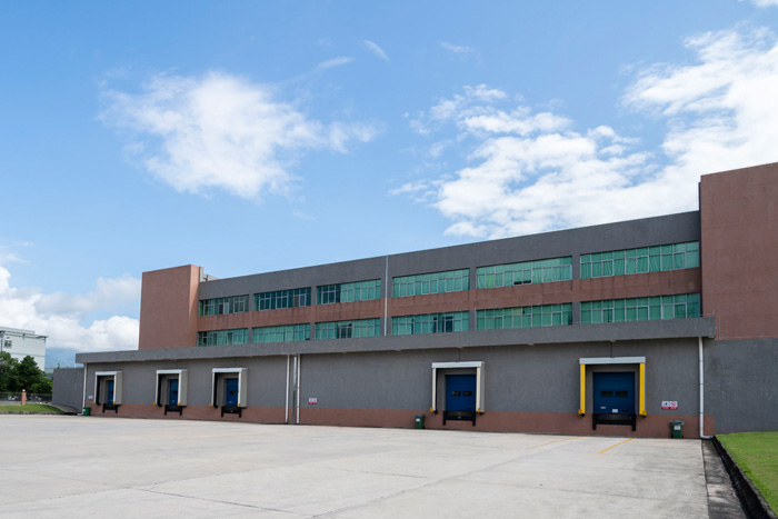 The building where trucks off-load raw material and load finished good of hogan's factory in Guangdong.